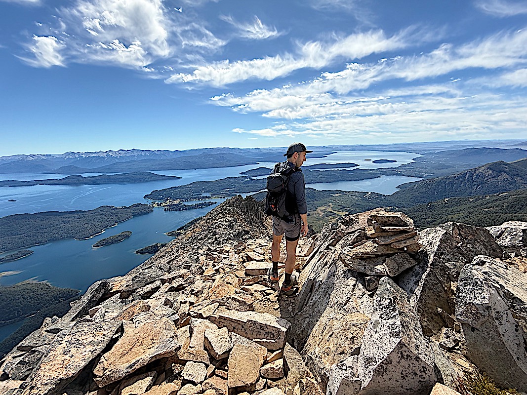 Trail runner on a rocky ridge high above the lakes of Nahuel Huapi National Park, Patagonia