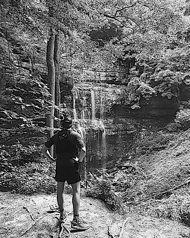 Runner beside a waterfall
